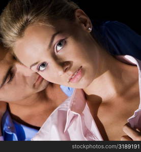 Close-up of a young man kissing a young woman