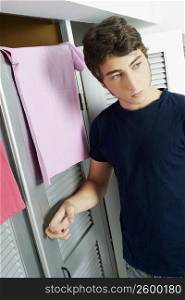 Close-up of a young man knocking on the door of a fitting room