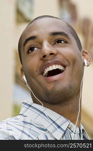 Close-up of a young man listening to music