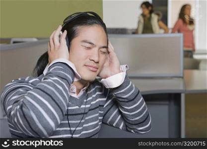 Close-up of a young man listening to music with his eyes closed