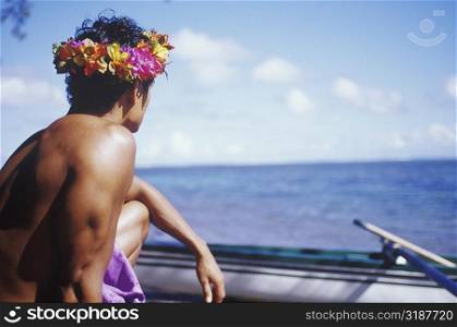 Close-up of a young man looking at a boat, Hawaii, USA