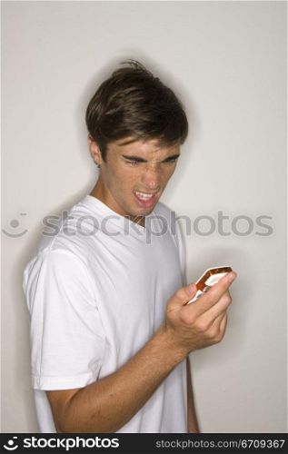 Close-up of a young man looking at a mobile phone