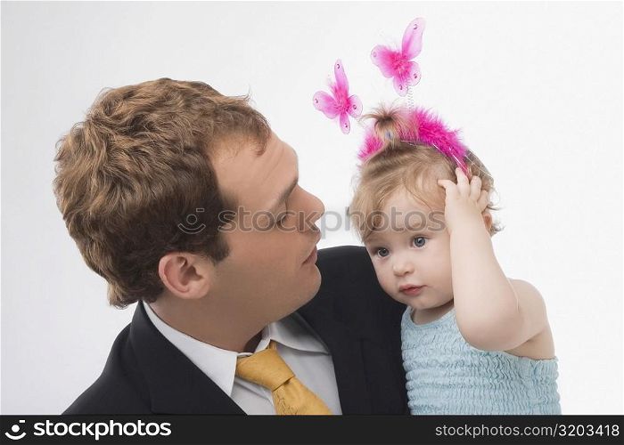 Close-up of a young man looking at his daughter