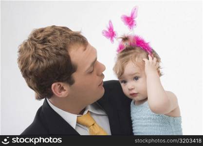 Close-up of a young man looking at his daughter