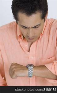 Close-up of a young man looking at his watch