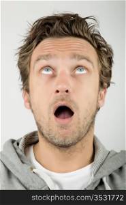 Close up of a young man looking surprised