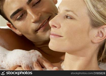 Close-up of a young man massaging a young woman