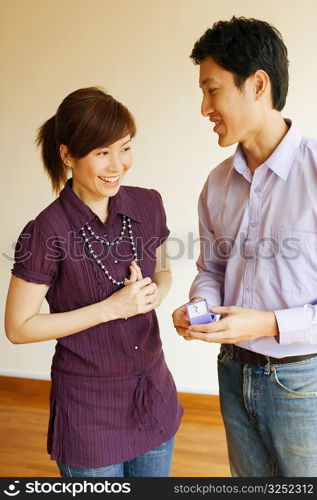 Close-up of a young man offering a ring to a young woman