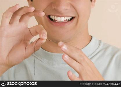 Close-up of a young man pinching a needle in his finger