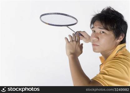 Close-up of a young man playing badminton