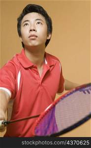 Close-up of a young man playing badminton