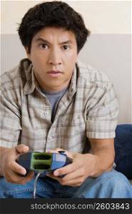 Close-up of a young man playing video game