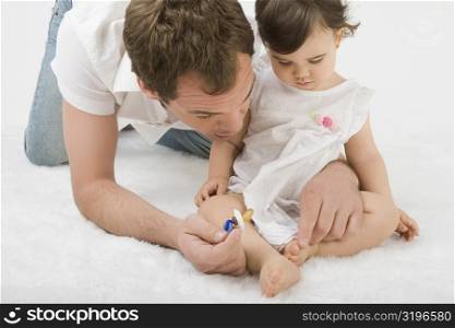 Close-up of a young man playing with his daughter