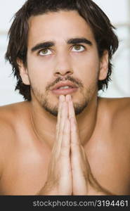 Close-up of a young man praying