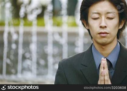 Close-up of a young man praying