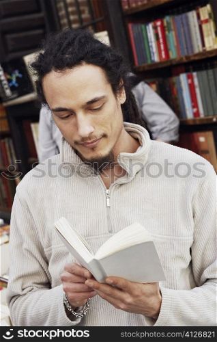 Close-up of a young man reading a book in a library