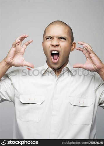 Close-up of a young man screaming with anger