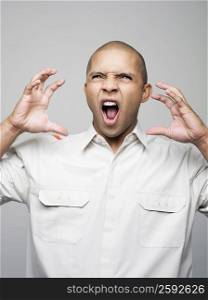 Close-up of a young man screaming with anger