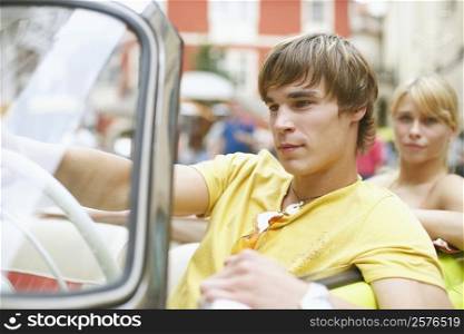Close-up of a young man sitting in a car