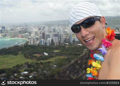 Close-up of a young man smiling, Diamond Head, Waikiki Beach, Honolulu, Oahu, Hawaii Islands, USA
