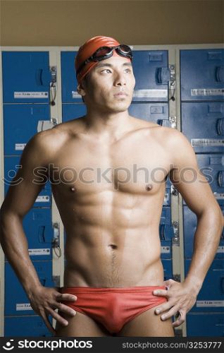 Close-up of a young man standing in a locker room