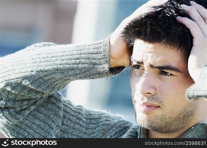 Close-up of a young man suffering from a headache