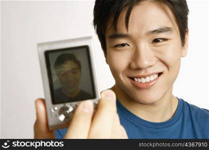 Close-up of a young man taking a picture of himself