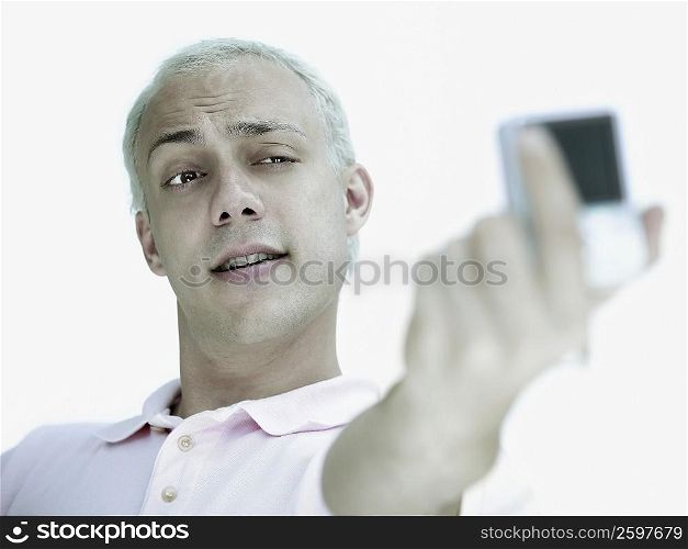 Close-up of a young man taking a self portrait with a digital camera