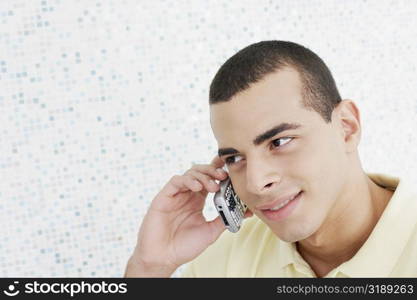 Close-up of a young man talking on a mobile phone