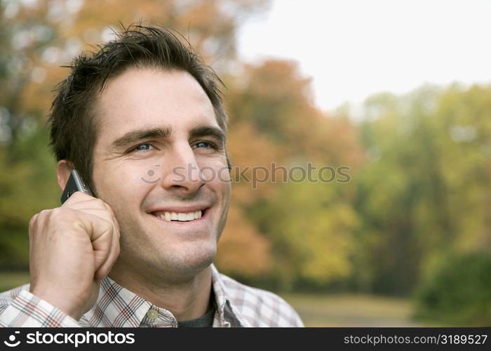 Close-up of a young man talking on a mobile phone