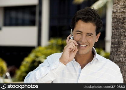 Close-up of a young man talking on a mobile phone