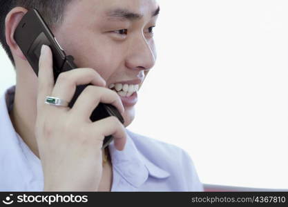 Close-up of a young man talking on a mobile phone