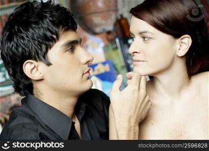 Close-up of a young man touching a young woman&acute;s chin