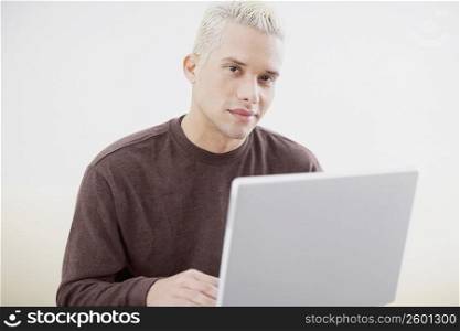 Close-up of a young man using a laptop
