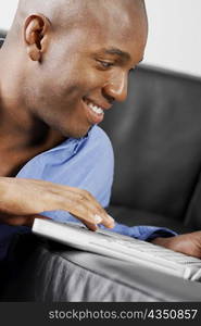 Close-up of a young man using a laptop