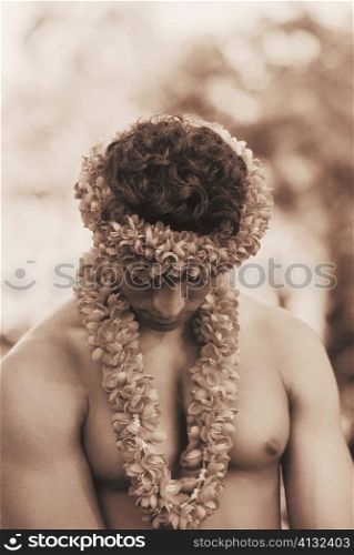 Close-up of a young man wearing a garland, Hawaii, USA
