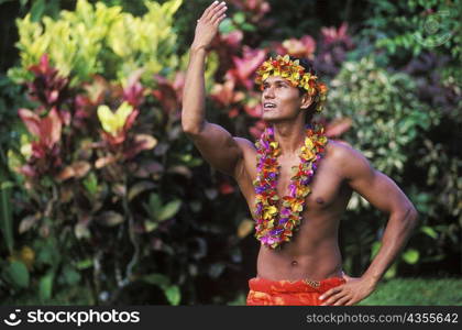 Close-up of a young man wearing a garland, Hawaii, USA