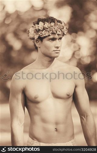 Close-up of a young man wearing a laurel wreath, Hawaii, USA