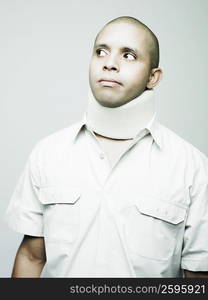 Close-up of a young man wearing a neck brace