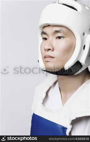 Close-up of a young man wearing a sports helmet