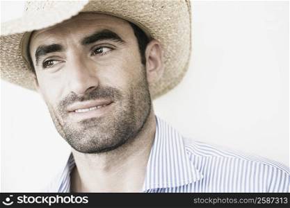 Close-up of a young man wearing a straw hat