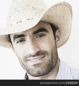 Close-up of a young man wearing a straw hat