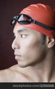 Close-up of a young man wearing a swimming cap