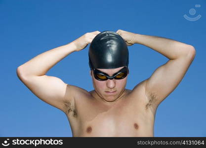 Close-up of a young man wearing a swimming cap