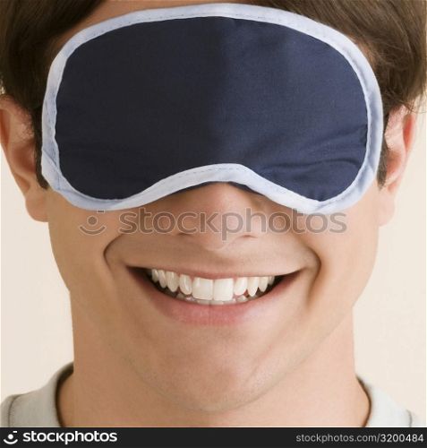 Close-up of a young man wearing an eye mask