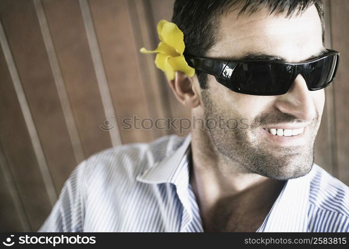 Close-up of a young man wearing sunglasses and smiling