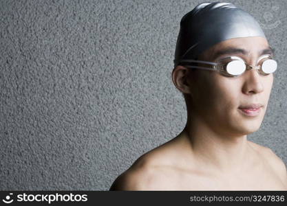 Close-up of a young man wearing swimming goggles