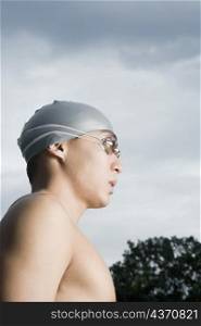 Close-up of a young man wearing swimming goggles