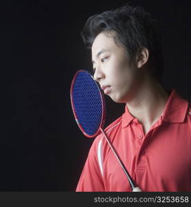 Close-up of a young man with a badminton racket