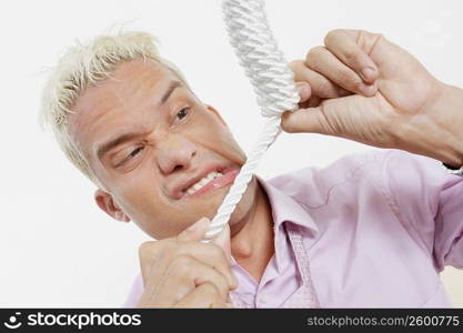 Close-up of a young man with a noose around his neck